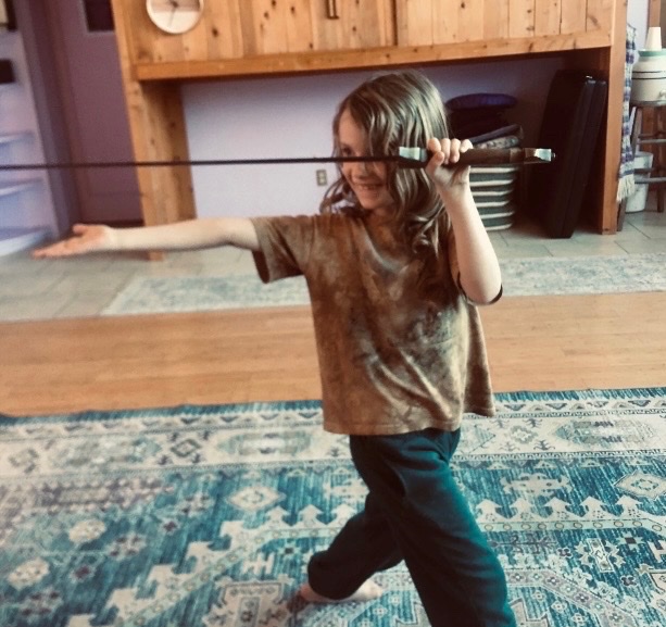 A young student practicing a sword movement